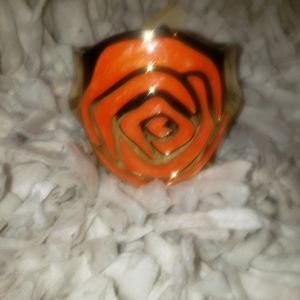 Gold bracelet with an orange floral design